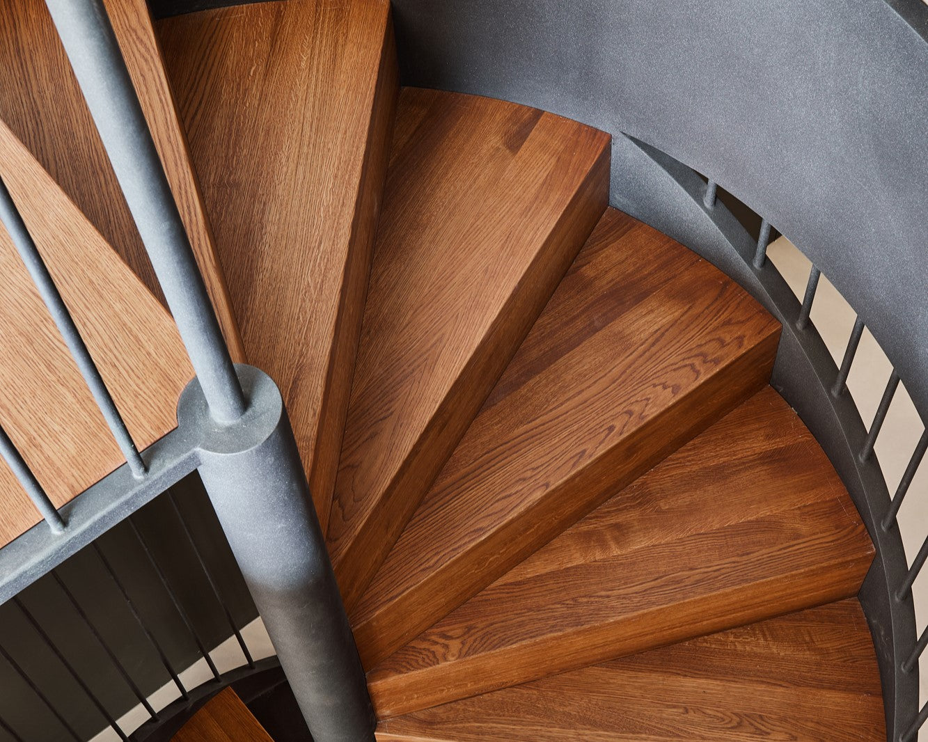 A spiral staircase made from European oak wood finished with Rubio Monocoat Oil Plus 2C hardwax oil wood finish offering increased protection for wooden floors.