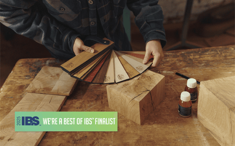 A man holding a wood fan deck finished with Oil Plus 2C hardwax oil wood finish for interior wood projects. Also pictured is a Best of IBS Finalist medallion.