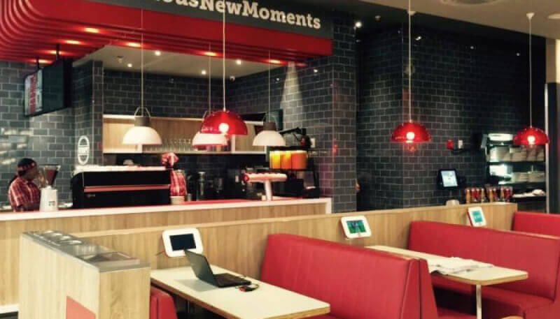 Wood tables in a food court finished using Rubio Monocoat wood finish.