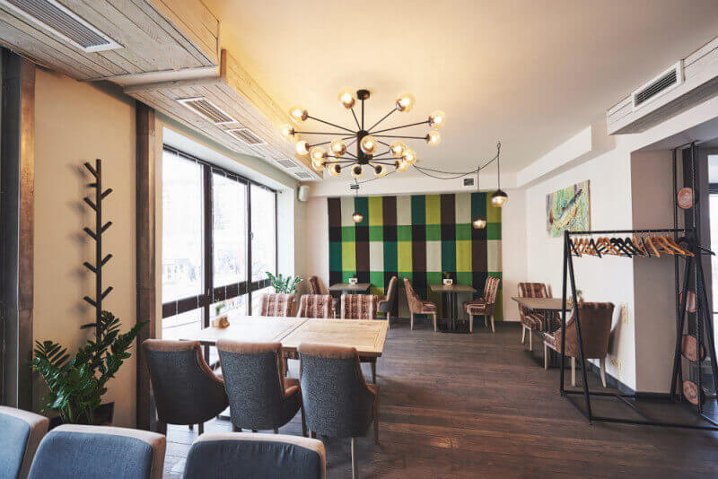 A dining room in a restaurant with hardwood flooring with a matte finish on it.