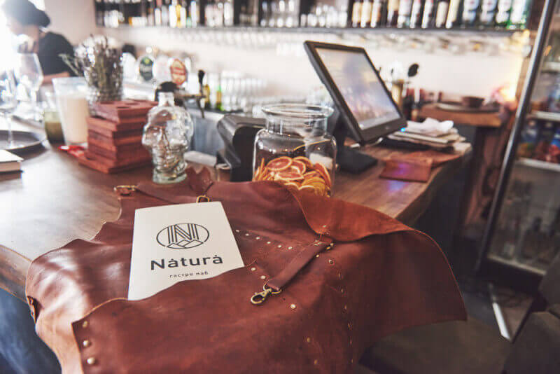 A leather apron on a counter in a restaurant.