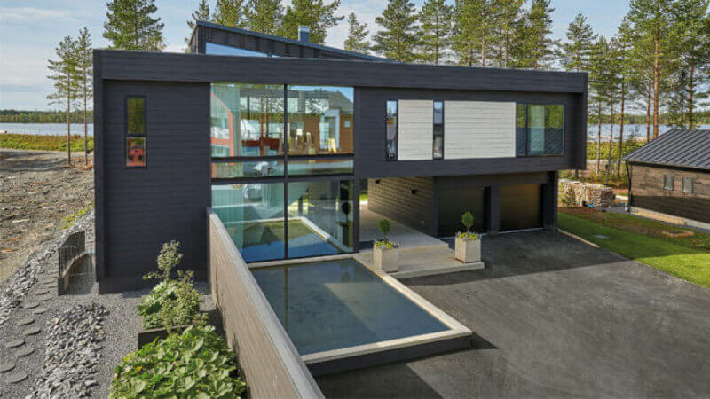 A beautiful new modern home with wood siding finished with Hybrid Wood Protector wood finish.