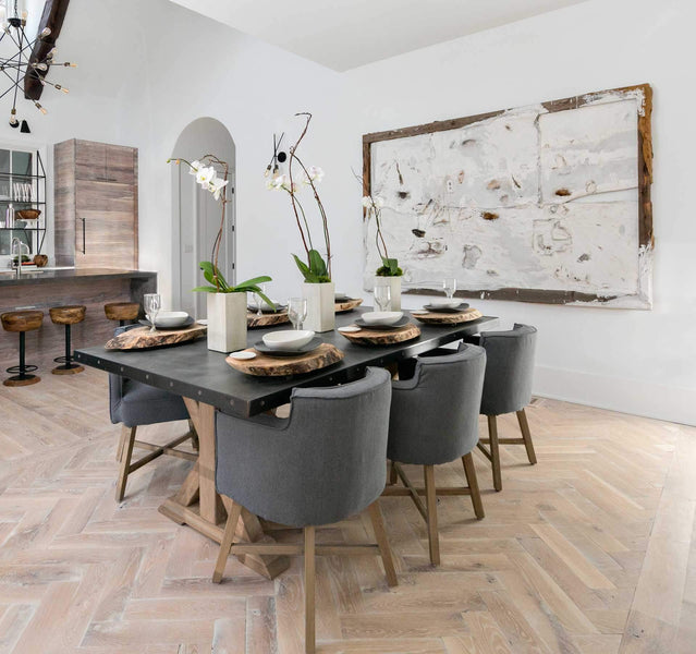 A light and airy dining room with light herringbone hardwood flooring finished in a natural wood oil.