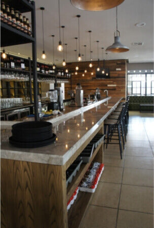 A wooden counter inside of a restaurant finished with natural plant-based wood finish.