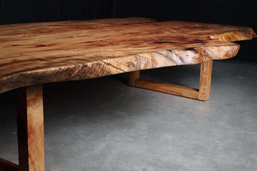 Live edge detail on a modern coffee table made from camphor.