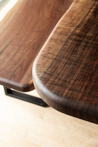 A detail shot of the grain of a beautiful claro walnut dining table.