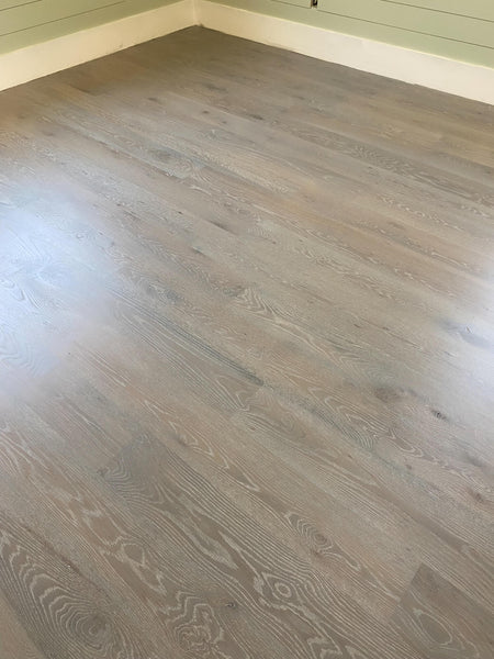 A cerused white oak wood floor stained and finished with Rubio Monocoat products. 