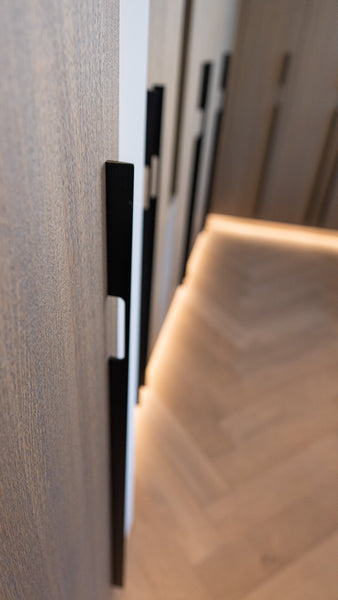 Close up of an oak veneered closet door finished with Rubio Monocoat Oil Plus 2C Silver Grey.