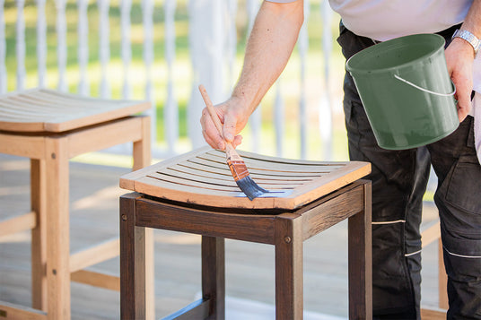 Professional painter applying Rubio Monocoat DuroGrit on deck chairs