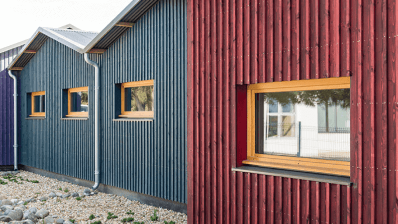 Colorful wooden buildings using an exterior paint alternative.