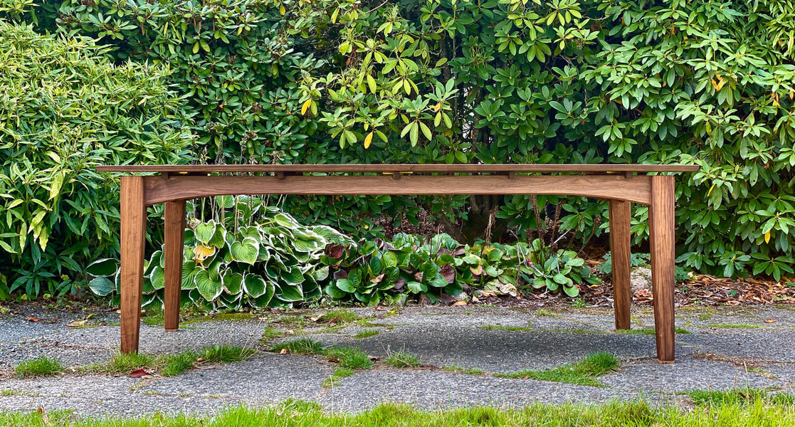 Solid walnut dining table with oil finished wood surface.