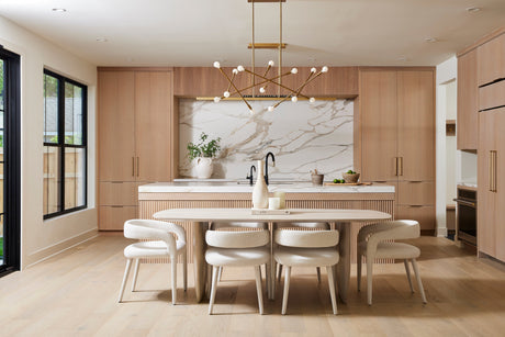 Light wood kitchen and dining area with finished cabinetry and table