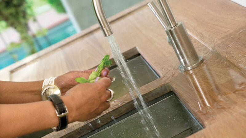 Wooden counter top finished with Rubio Monocoat repels water.