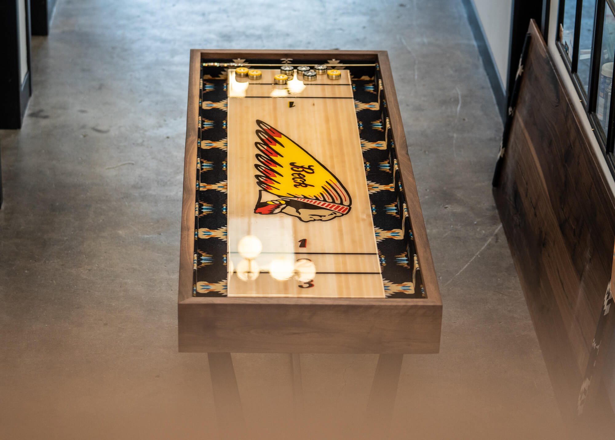 A custom shuffleboard made from walnut and finished with Rubio Monocoat Oil Plus 2C.