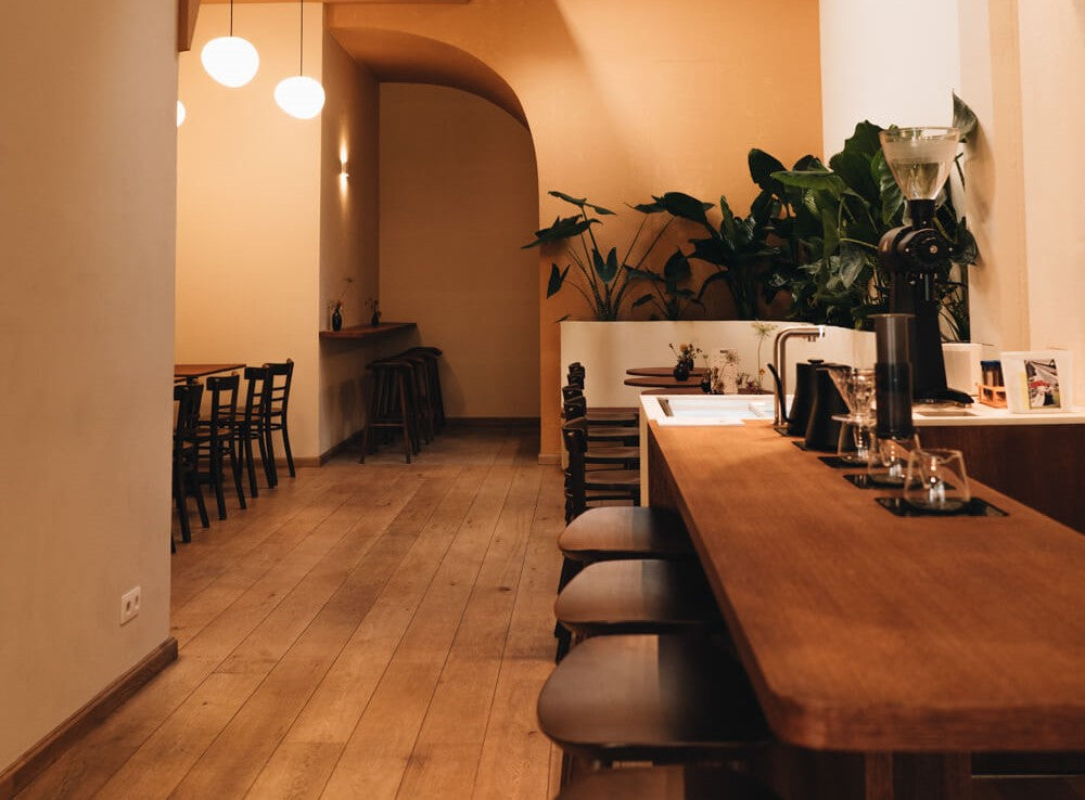 A warm, inviting seating area in a quant yet modern coffee shop.