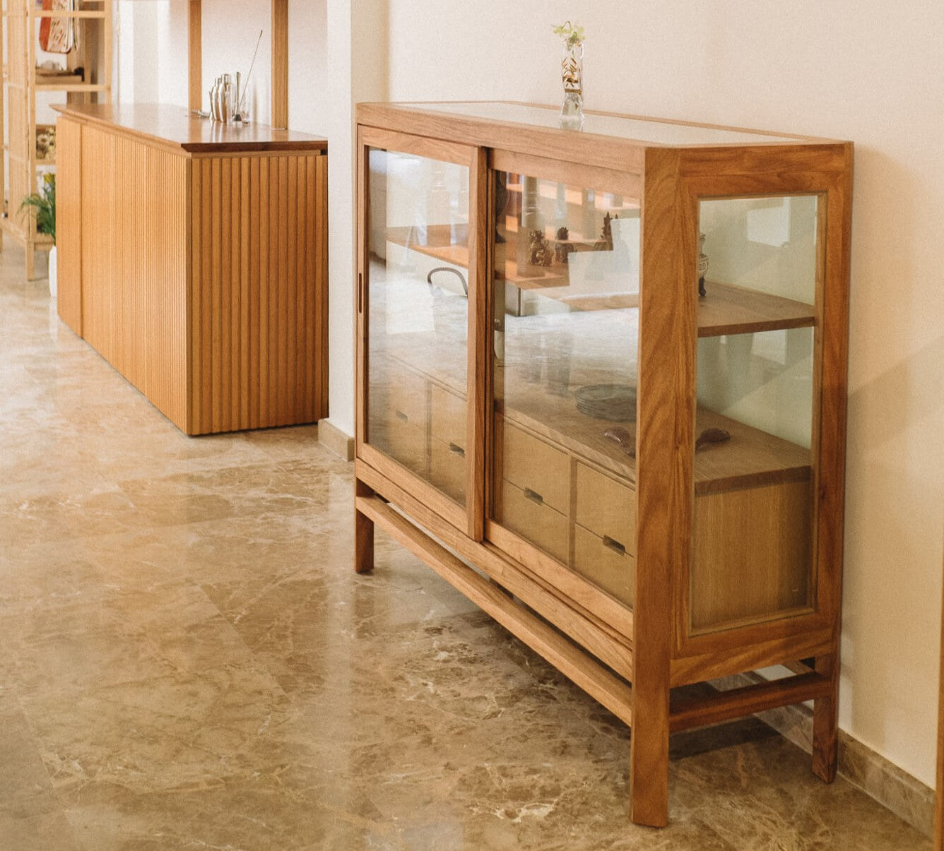 A display cabinet with sliding glass doors made from exotic hardwood and finished with Oil Plus 2C hardwax oil finish.