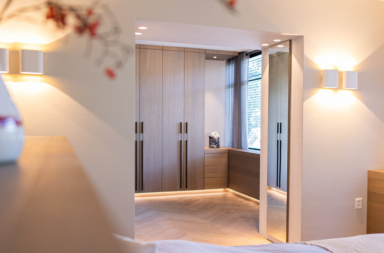 A doorway looking into a closet crafted from oak veneer and finished with Rubio Monocoat Oil Plus 2C.