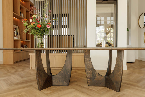 Project inspiration for a sculptural, modern dining table made from oak and finished with Rubio Monocoat Oil Plus 2C "Black" single layer wood stain and finish for interior projects.