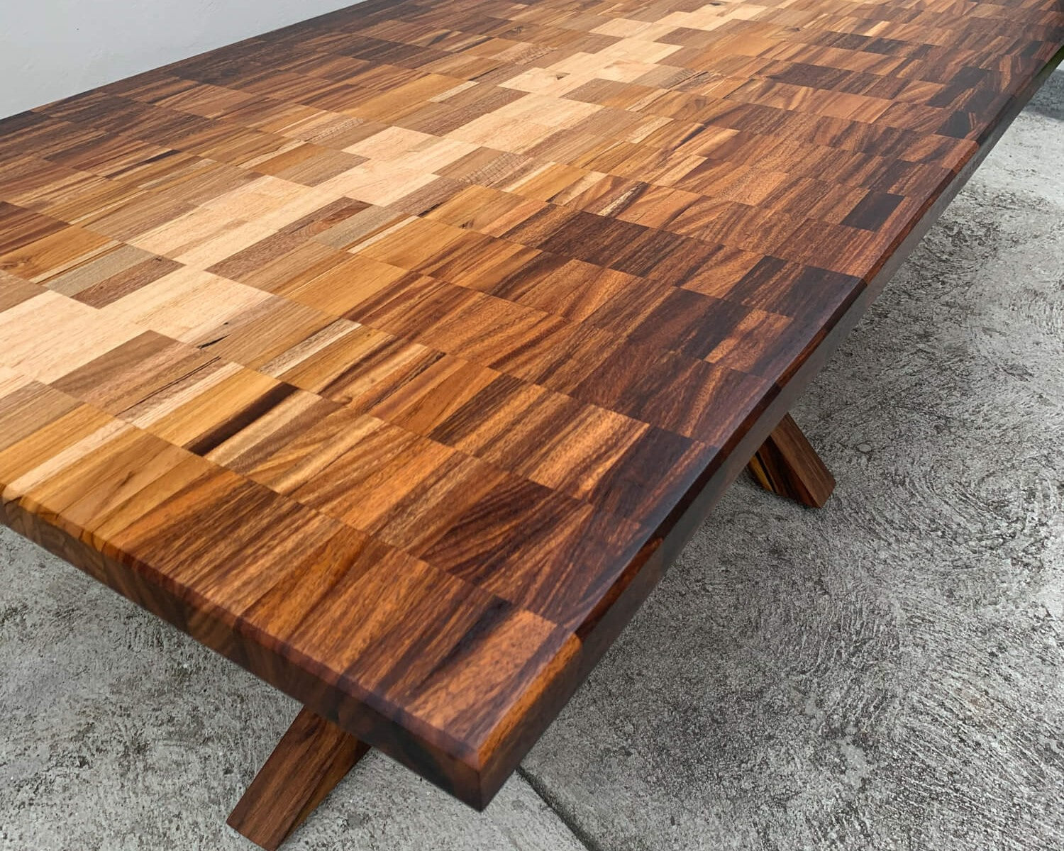 A tabletop made from a variety of different hardwood species arranged in an ombré pattern.