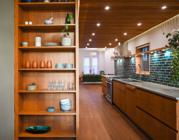 Shelving situated off a galley kitchen made from white oak and finished with Oil Plus 2C in the color "Ice Brown".