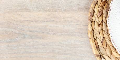 A white wood stain colored finish on a dining table top.