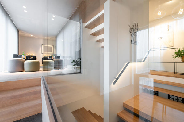 A modern oak staircase encased in glass and finished with Oil Plus 2C hardwax oil wood finish for interior projects.