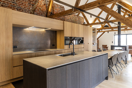 Modern interior kitchen with finished wood cabinetry and exposed timber beams