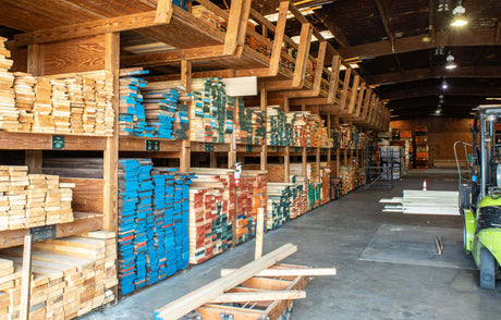 A lumberyard with multiple wood species laid out for selection