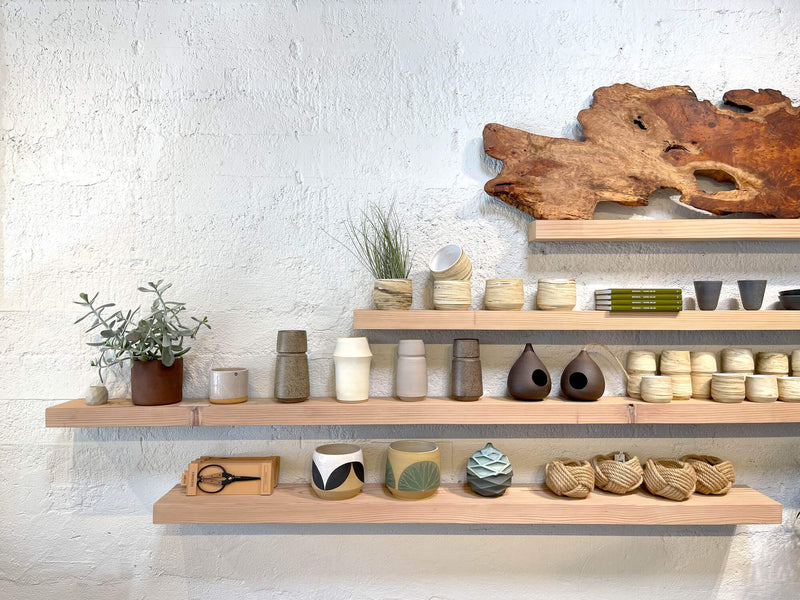 Pottery and other artifacts stationed on floating shelves made from redwood and finished with Oil Plus 2C Smoke.