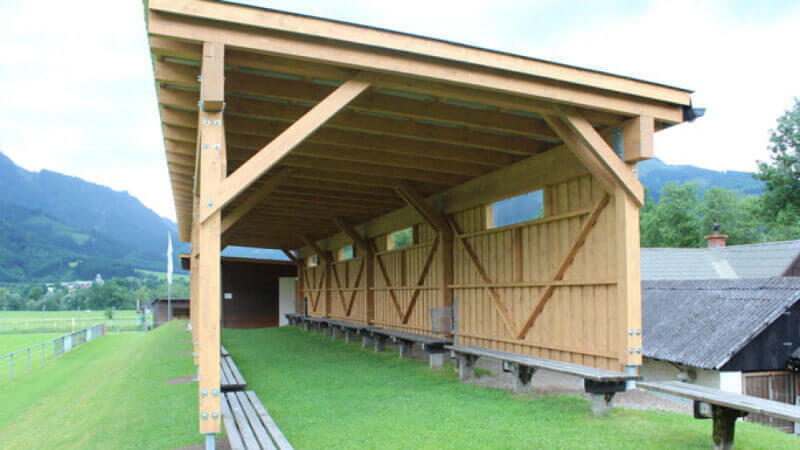 A long wooden covering for outdoor gatherings.