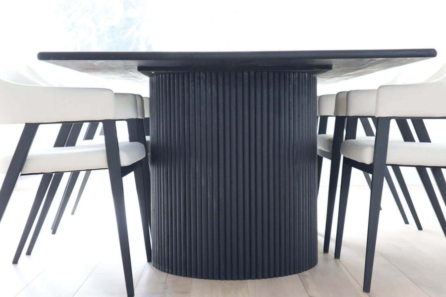 A head on shot of one of the fluted bases on a modern fluted dining table finished with a monotone black wood finish.