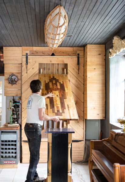 A man is unfolding the murphy bar.