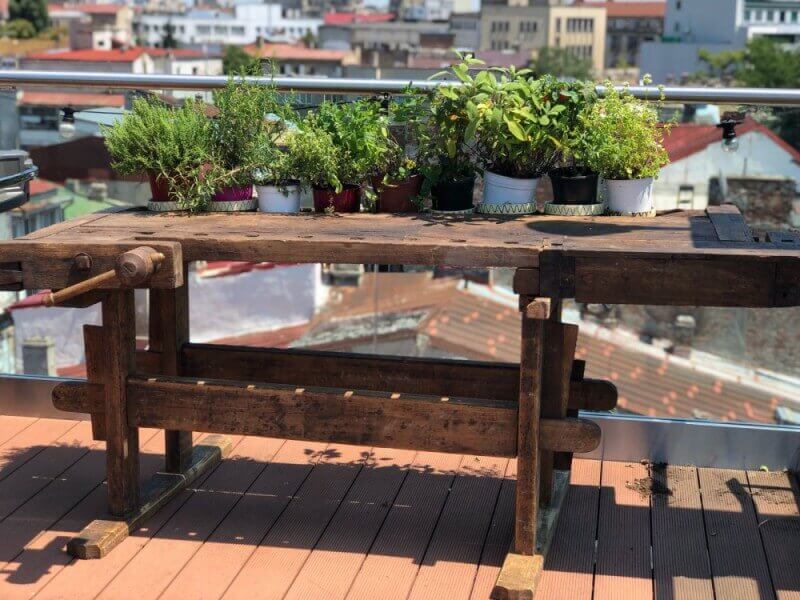 An old workbench recently renovated and set on a terrace.