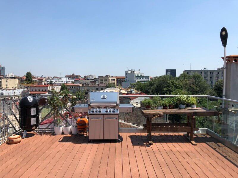 A renovated workbench on a terrace overlooking a city.