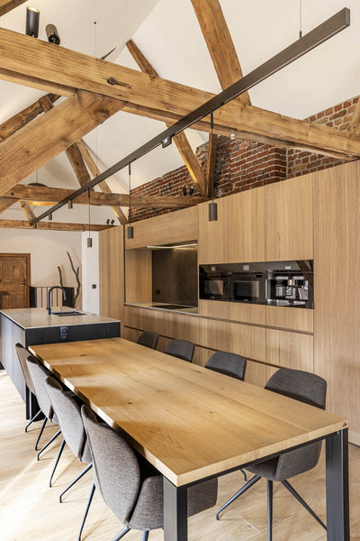 Light wood dining table that is an extension of the island finished with Oil Plus 2C hardwax oil wood finish.