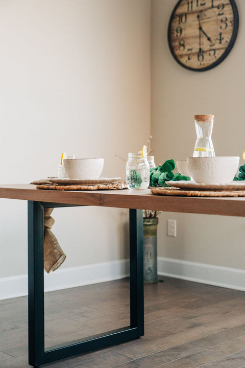 A coastal-inspired white oak table with modern steel table legs.