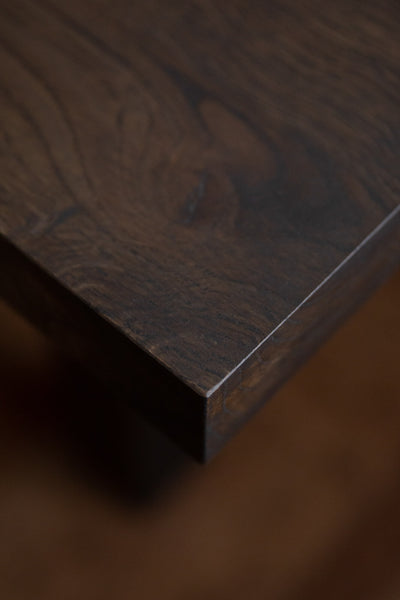 A white oak table finished with a bold, dark finish.