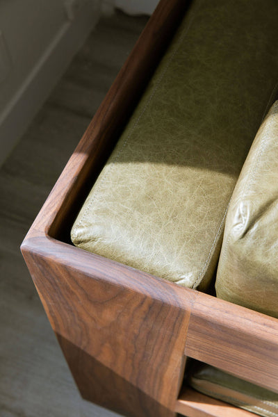 Corner details of a custom walnut and leather sofa.