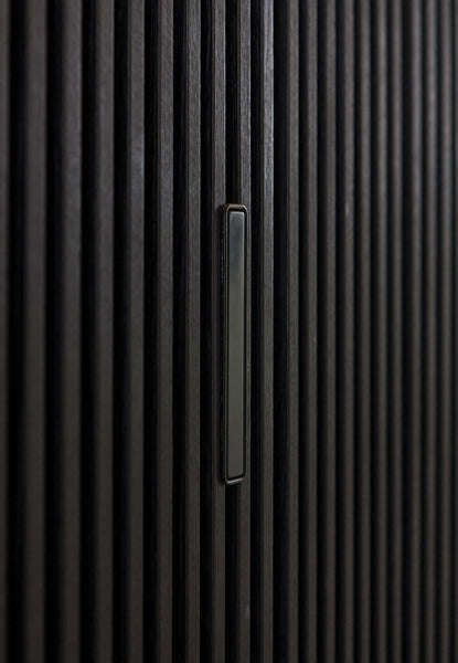 A close up of the handle to the hidden door in the black slatted wall.