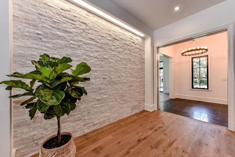 Stone wall against wood floors finished with Rubio Monocoat.