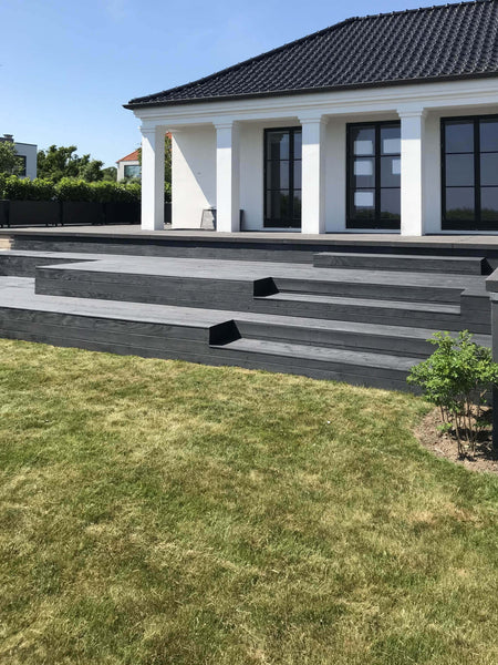 Wood deck in back yard finished with dark decking oil.
