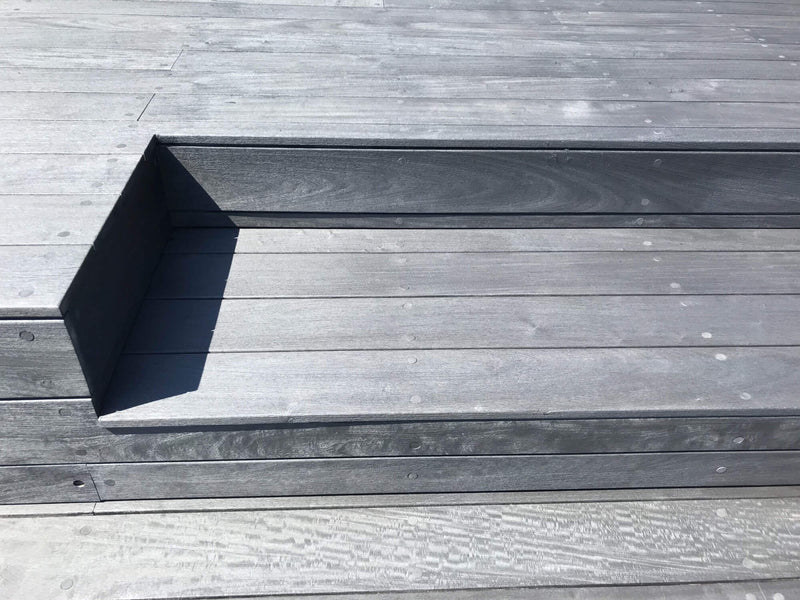 Ipe steps with dark colored decking on on them.