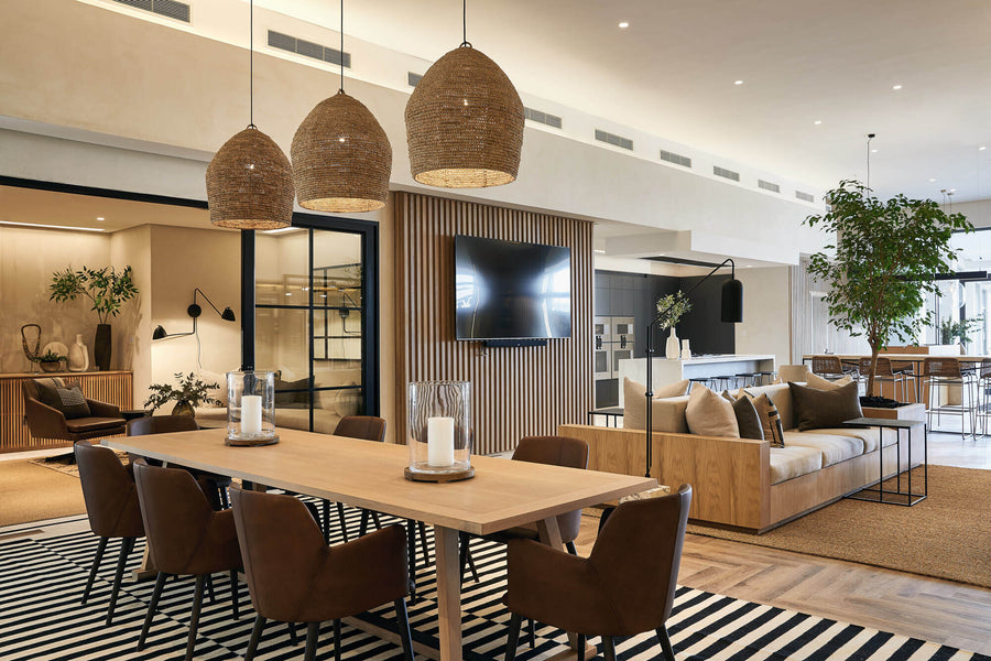 A conference table with three hanging pendent lights looking into a seating area with a variety of white oak elements finished with Oil Plus 2C hardwax oil wood finish.