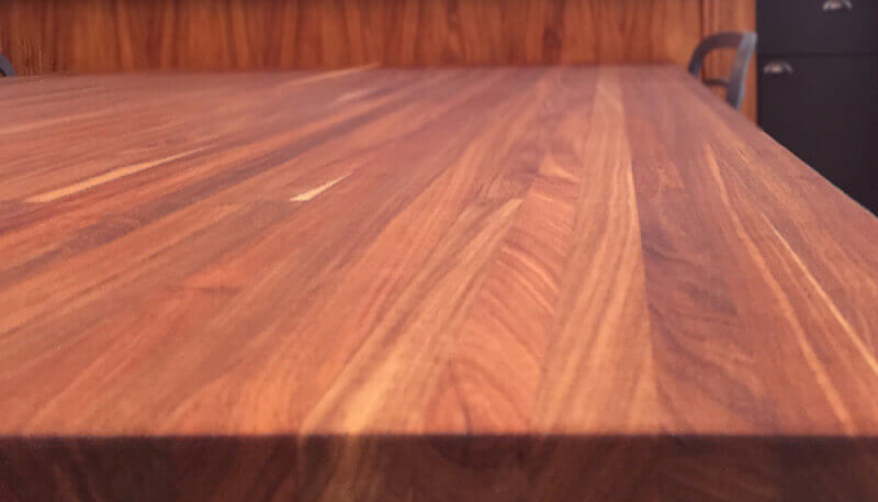 A close up detail of a hardax oil finished solid wood table.