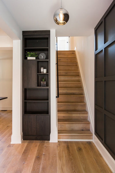 Oak stair treads leading upstairs in a house.