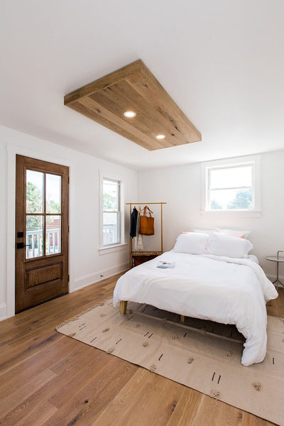White Oak flooring in bedroom with door to outside.