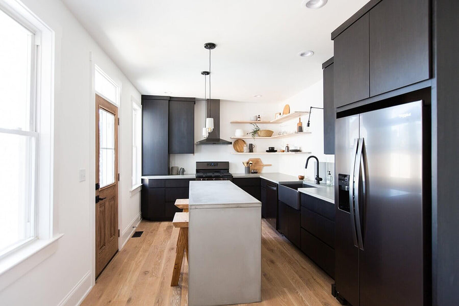 Modern kitchen with white oak floors and dark cabinets.