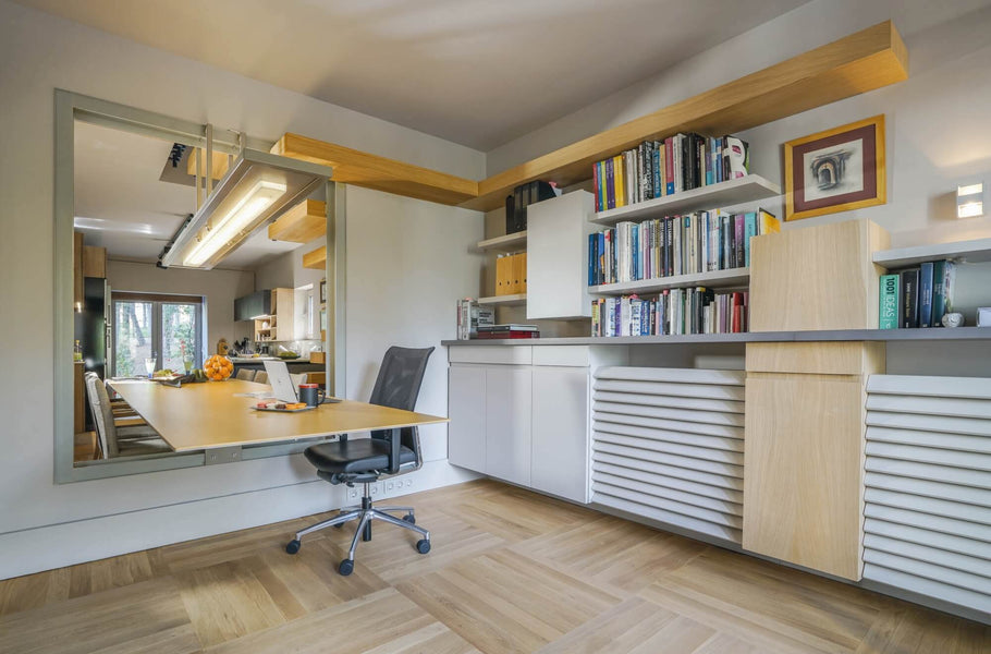 Home office with desk passing through a window for use in and out of the office.