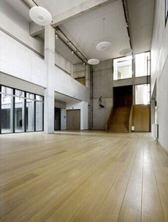 A large room in a school with hardwood flooring