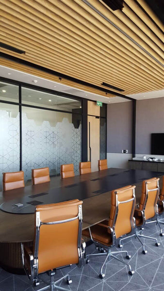 Wooden cladding on ceiling of conference room.